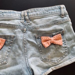 bow back distressed shorts